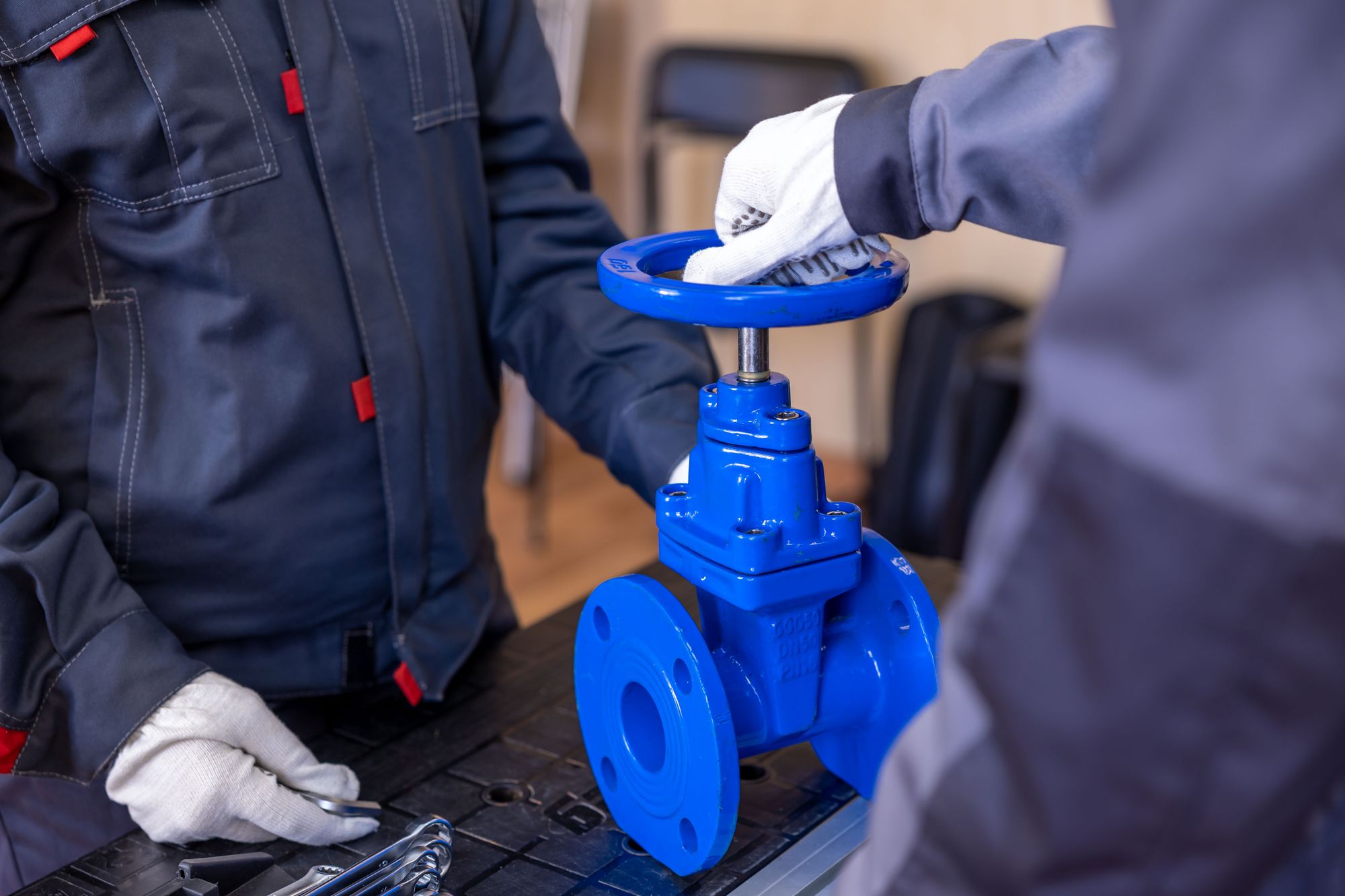Technicians servicing valve equipment in a workshop